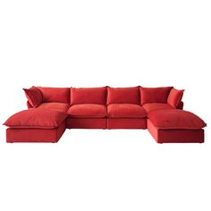 a red sectional couch with pillows on it's back and the seat folded out