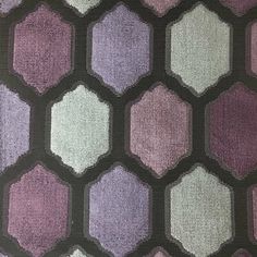 an upholstered purple and white rug with hexagonal shapes on it's sides