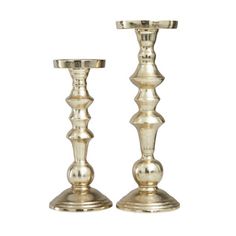 two silver candlesticks sitting next to each other