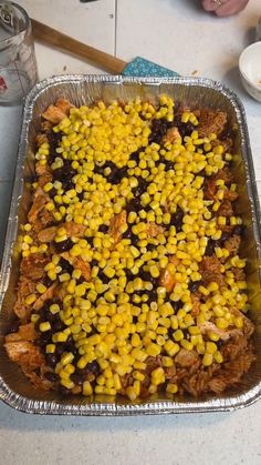 a metal pan filled with corn on the cob