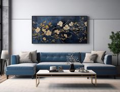 a living room with a blue couch and coffee table in front of a painting on the wall