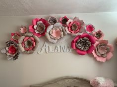 there is a wall decoration with pink flowers on the wall and letters above it that say atlanta