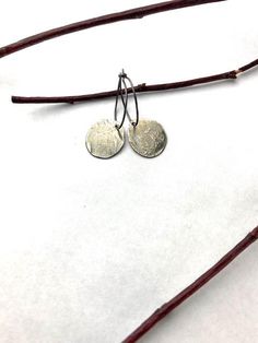 One of my personal favorites, these are my "go to" earrings! My leftover silver gets melted and hammered into these lightweight disks that have subtle character with a soft silver patina. A classic look, these earrings will always be in style no matter where you go! Hanging from a sterling silver wire hoop, they measure about 1 1/4" from top to bottom. Free shipping in the USA! Shipped in a gift box ready for giving! Due to the custom nature of these earrings, no two are alike. Slight variations Hammered Sterling Silver Round Disc Earrings, Everyday Small Hoop Hammered Earrings, Silver Hammered Circle Earrings, Hammered Silver Round Disc Earrings, Silver Stamped Earrings For Everyday, Small Hoop Hammered Silver Earrings, Silver Round Disc Earrings For Everyday Wear, Everyday Silver Stamped Earrings, Everyday Silver Round Disc Earrings