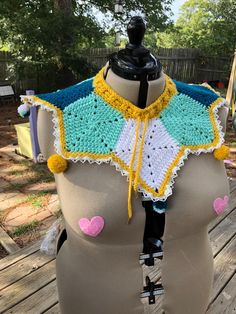 a mannequin wearing a crocheted top with hearts on it's chest