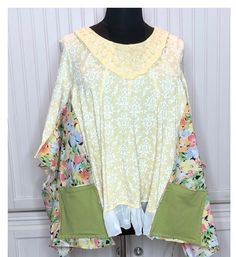 This easy fitting women's tee shirt tunic is made from a yellow and white print embroidered cotton tee, a floral print cotton, and some vintage lace.  The inspiration started with the embroidered yellow tee. I wanted to honor the beauty of this top, but upcycle it into an easy fitting piece. The yellow tee was used as the center base piece and the sides and sleeves were upsized using the floral print cotton, and the vintage lace was used to extend the hemline. The sides and hem flow gracefully. There are two large green cotton side pockets.  The dress is a comfortable fitting women's XXL free size that flares gently at the sides under the kimono sleeves.  I think the technique used make this a very slimming fit. See measurements below.  As always, I fell in love with the material of this s Green Cotton Blouse With Patchwork, Green Cotton Patchwork Blouse, Green Patchwork Cotton Blouse, Spring Lagenlook Blouse Relaxed Fit, Cotton Tops Free Size For Spring, Spring Green Patchwork Blouse, Free Size Long Sleeve Tops For Spring, Spring Cotton Free Size Tops, Spring Daywear Tunic Tops