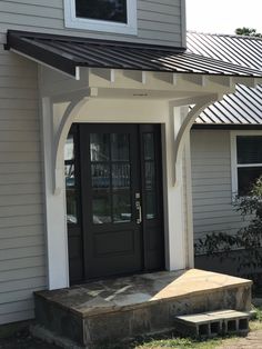 a house with a black front door and white trim