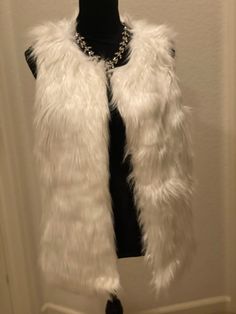 THIS ITEM IS HEAVY AND MUST USE THE “TWO ITEMS” SHIPPING. This is a beautiful brand new vest from the Delia’s brand. The best is all white made of polyester and acrylic. It is sleeveless and a size large. It has one clasp closure on the top front. Ships immediately! Excellent Condition. Bust: 40” +Waist: 44” +Length: 27” Type: Vest Brand: Delia's Size Type: Regular Women's Size: L Material: Acrylic, Polyester Season: Fall - Winter Colors: Yellow Condition: New With Tags Washing Instruction: Dry White Sleeveless Vest For Winter, White Sleeveless Winter Vest, Winter Colors, All White, Fur Coat, Two By Two, Fall Winter, Dry Clean, Womens Sizes