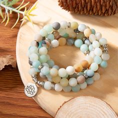 Amazonite is a soothing stone. Wear it and you will immediately feel a sense of inner peace and balance. It possesses a powerful energy, like the river of which it bears the name, but it is nevertheless capable of taming and calming negativity and anger.This splendid Mala bracelet is carefully handmade with 108 natural genuine matte Amazonite and Rodhonite gemstone beads. It can be worn as a bracelet, necklace or used for meditation. Length is about 23.6 inches (60 cm) and is elastic. 3 charms a Agate Meditation Bracelets With 108 Beads, Agate Bracelets With 108 Beads For Meditation, Agate Beaded Bracelets With 108 Beads For Meditation, Spiritual Amazonite 8mm Beads Jewelry, Spiritual Amazonite Jewelry With 8mm Beads, Holistic Beaded Bracelets With Round Beads For Meditation, Meditation Beaded Bracelets With Amazonite, Amazonite Beaded Bracelets For Meditation, Meditation Bracelets With 8mm Beads