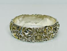 Vintage Repousse Sterling Silver Bangle Stamped 925 Ornate Thick Silver Bangle Up for sale is this gorgeous repousse sterling silver bangle, stamped 925. It is one inch wide, with a circumference measured from the inside of 8 1/2 inches (2 5/8 inches diameter.) Stunning ornate design, some of the flowers have gold gilt to add dimension to the piece. It weighs 33 grams. Very good condition as you can see from the photos. Please see the photos and the video for a more detailed description of this Luxury Vintage Filigree Bangle, Luxury Ornate Sterling Silver Bangle, Ornate Design, Sterling Silver Bangle, Sterling Silver Bangles, Silver Bangle, One Inch, Silver Bangles, Bangle Bracelets