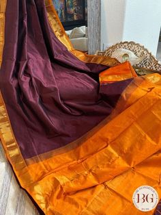 Indulge in the luxury of our Kanjeevaram silk cotton handloom saree. Experience the elegance of Maroon Orange and the intricate craftsmanship of handloom weaving. This saree is a timeless fusion of tradition and style that will make you stand out in any occasion. Kanjeevaram silk cotton handloom saree - Maroon Orange Saree comes with a blouse piece. Fall and pico done. Fully stitched blouse shown in pictures is optional and can be purchased seperately from our blouses and croptops section. For saree video please connect with us on whatsapp @469-937-0606 Ready to be shipped in USA from San Diego, California. All pictures are original pictures. Colors may slightly vary due to pic resolution. Festival Cotton Silk Pre-draped Saree With Border, Cotton Silk Saree With Border In Traditional Drape, Cotton Silk Saree With Traditional Drape And Border, Handloom Cotton Silk Saree For Puja, Cotton Silk Saree With Weaving Work For Puja, Traditional Drape Cotton Silk Saree With Border, Anarkali Cotton Silk Saree With Border, Handloom Cotton Silk Saree For Festivals, Cotton Silk Saree With Border For Puja