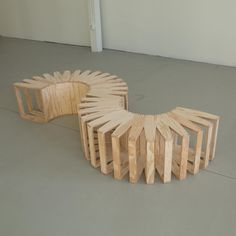 two wooden sculptures sitting on top of a cement floor