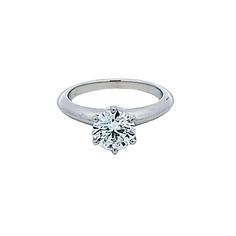 a white gold ring with a single diamond