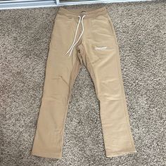 Brand New Never Worn Originally $130+ Slight Flare At Bottom Waist: 14” (Stretchy) Inseam: 30.5” Feel Free To Send Me An Offer! I Will Ship Out The Same Or Next Day Of Purchase! (: Fitted Beige Pants For Streetwear, Beige Tapered Leg Bottoms For Streetwear, Sporty Beige Straight Leg Bottoms, Stretch Beige Bottoms For Streetwear, Sporty Cream Cotton Pants, Sporty Cream Pants With Pockets, Cream Cotton Pants For Streetwear, Sporty Beige Streetwear Bottoms, Beige Cotton Athleisure Pants