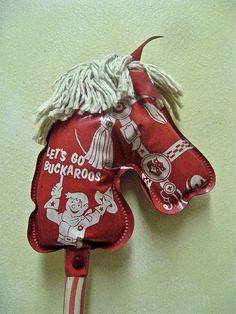 a red and white horse head hanging on the wall