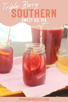 two mason jars filled with purple liquid and orange slices