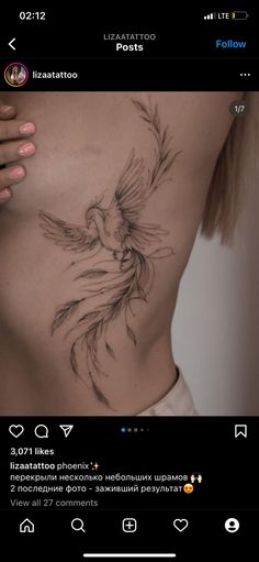 a woman's stomach with a bird tattoo on it