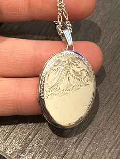 Here is a beautiful vintage solid silver locket. It has a lovely front panel of etched scrolls on the front , It measures approximately 4cm in height including the bail and 2.3cm in width. It remains in excellent condition with no damage. I have put it on a 18 inch silver chain. Classic Silver Locket Necklace With Round Pendant, Elegant Pendant Locket Necklace, White Gold Oval Pendant Locket Necklace, Classic Silver Locket Necklace, Classic Silver Locket Necklace With Oval Link, Classic Oval Antique Silver Necklace, Silver Locket Necklace With Intricate Design For Formal Occasions, Classic Antique Silver Oval Necklace, Elegant Round Pendant Locket Necklace Stamped 925