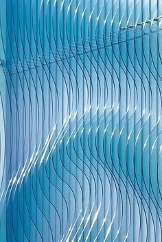 an abstract blue background with wavy lines on the outside and inside, as well as light coming from above