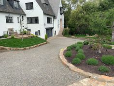 a large white house with landscaping around it