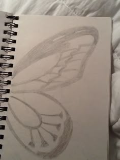 a drawing of a butterfly on top of a bed