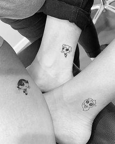 two people with matching tattoos on their legs, one has a dog and the other has a sheep