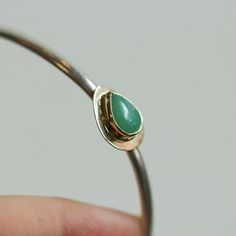 We are excited to offer this stunning Green Jade bracelet in solid 14K Solid gold and .925 Sterling Silver. Simple yet elegant bracelet and it's super easy to wear alone or stacked with other bracelets, and the green jade color is absolutely magnificent! The elegance of green jade is undeniable and elusive and in this dressy jade bracelet, it is no different. This green jade is particularly rich in its natural green majesty. We've surrounded the gorgeous green jade pear-shaped cabochon in Solid Formal White Gold Bracelet, 14k Gold Hallmarked Cuff Bracelet As Gift, 14k Gold Hallmarked Cuff Bracelet For Anniversary, Hallmarked 14k Gold Cuff Bracelet For Anniversary, 14k White Gold Cuff Bracelet Gift, Silver And 14k Gold Cuff Bangle, Silver 14k Gold Cuff Bangle Bracelet, Formal Yellow Gold Sterling Silver Bangle, Yellow Gold Sterling Silver Bangle For Formal Occasions