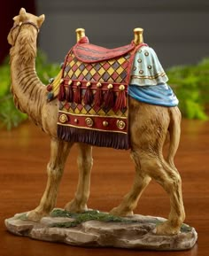 a figurine of a camel with a saddle on its back