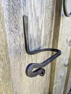 an iron handle on a wooden door