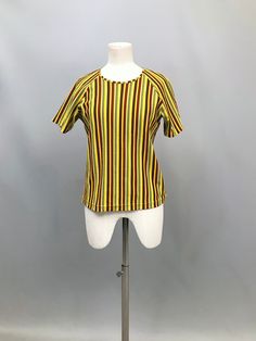 1970s Bright yellow green and brown stripy t - shirt  An awesome 70's classic, perfect for under dungarees or with high waisted jeans  polyester fabric  crew neck  Label says Judy collection  Raglan sleeve- fits most shoulders Size 12 UK Armpit to armpit 20" Length 23" All items are shipped with tracking Retro Fitted Green T-shirt, Striped Stretch Cotton T-shirt, Vertical Striped Fitted Tops, Fitted Striped T-shirt For Spring, Retro Striped T-shirt For Summer, Retro Mustard Cotton Top, Retro Striped Relaxed Fit Tops, Retro Striped Tops With Relaxed Fit, Fitted Striped Cotton T-shirt