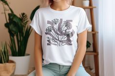 Elevate your wardrobe with our beautiful Botanical Shirt featuring an exquisite wildflower design. Perfect for gardening enthusiasts, this Wildflower Shirt captures the essence of nature's beauty. Whether you're planting in the garden or simply embracing a nature-inspired aesthetic, this Gardening Shirt is a must-have. Embrace the Cottagecore trend with our Cottagecore Shirt and Plant Lady Shirt, showcasing a vintage floral design that brings a touch of nostalgia to your outfit. This Vintage Flo Vintage Floral Shirt, Lavender Shirt, Botanical Theme, Vintage Lavender, Cottagecore Shirt, Boho Tees, Botanical Shirt, Nature Shirts, Gardening Shirts