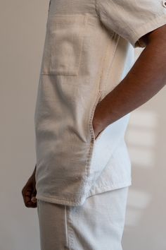 Beige Cotton Tops With Patch Pockets, White Short Sleeve Shirt With Patch Pockets, White Short Sleeve Tops With Patch Pockets, Unstructured Short Sleeve Shirt With Pockets, Effortless Collared Cotton Shirt, White Camp Shirt With Pockets And Camp Collar, Casual Cotton Shirt With Side Pockets, White Relaxed Fit Camp Shirt With Pockets, White Casual Camp Shirt With Pockets