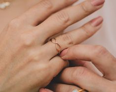 Discover the elegance of our Infinity Artisan Ring, meticulously handcrafted by our cherished artisans in our Northern California studio, employing sustainable and eco-friendly practices. This ring, available in 14 karat rose gold filled, 14 karat yellow gold filled, and .925 sterling silver, measures 1/2" long by 3/16" tall. Its delicate open infinity design gracefully encircles the finger, symbolizing everlasting connections. Handcrafted with meticulous artistry, it embodies the enduring natur Rose Gold Infinity Jewelry For Promise, Rose Gold Infinity Promise Jewelry, Minimalist Rose Gold Infinity Ring, Hypoallergenic Rose Gold Infinity Jewelry, Fine Jewelry Infinity Stackable Rings As Gift, Infinity Shape Stackable Fine Jewelry Rings As Gift, Fine Jewelry Stackable Infinity Rings As Gift, Adjustable 14k Rose Gold Rings For Gifts, Minimalist 14k Rose Gold Promise Jewelry