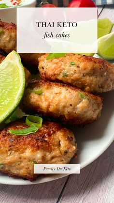 thai keto fish cakes on a white plate with limes and tomatoes in the background