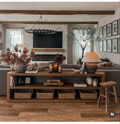 a living room filled with furniture and pictures on the wall