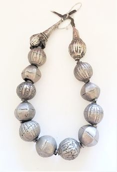 "Beautiful Large and heavy coin silver beads made by the Harrar people of Ethiopia. Very impressive indeed! The beads are handmade of a good silver alloy (though below sterling of course). The beads are hollow and filled with clay, resin or a similar substance to stabilize them. The necklace is traditionally strung on thread which is simply knotted at the back, allowing to be worn a bit longer or shorter. Of course the necklace could also be restrung. Collectors, however, may prefer it in its or Festival Silver Beaded Temple Necklace, Silver Beaded Temple Necklace For Festivals, Silver Necklaces With Polished Beads For Festival, Silver-tone Jewelry With Round Beads, Silver Jewelry With Silver Beads For Rituals, Silver Beaded Jewelry For Rituals, Artisan Silver Necklace For Rituals, Traditional Silver Temple Necklace With Beads, Traditional Silver Beaded Temple Necklace