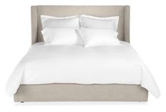 a bed with white sheets and pillows on top of it, against a white background