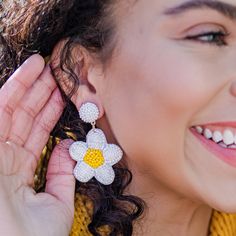 These Beaded White Daisy Earrings are the perfect way to radiate happiness and sunshine! All white with a yellow center, our daisies symbolize new beginnings and are perfect for a new school year or season in your life! These earrings are lightweight and comfortable for all-day wear. Details: Super lightweight at just 0.3 ounces Measures approximately 1 1/2 inches wide x 2 inches long Post backing Nickel-free Reverse side is a felt lining Radiate Happiness, Wild Rag, Daisy Earrings, White Daisy, Scarf Headband, New School Year, New School, Everyday Earrings, Appreciation Gifts