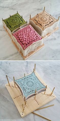 three different colored crocheted squares sitting on top of a wooden tray with knitting needles