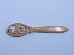 a wooden utensil with the word e & g carved into it's handle