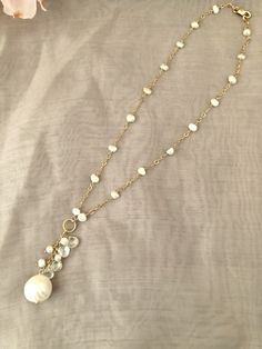 Simple and pretty freshwater pearl necklace, perfect for everyday wear. Pearls are large (12-14MM) round, white, which are slightly graduated in size. Some pearls contain irregularities, due to the organic nature of pearls.Five pearls are centered on the 3MM 14 GF cable chain.The necklace length is 19 1/4, but can be made shorter. A jump ring at the end of the necklace has a small (8MM) round white pearl to accentuate the closure, which is a 10MM 14K GF lobster clasp.All 14K GF and vermeil findi Pearl White Briolette Pearl Necklace For Weddings, Briolette Pearl Necklace For Weddings, Pearl White Necklace With Briolette Pearl Charm, Pearl White Briolette Pearl Drop Necklace, Briolette Pearl Charm Necklace For Wedding, Wedding Pearl Necklace With Briolette Charm, Briolette Pearl Necklace For Anniversary, Elegant Faceted Pearl Necklace, White Briolette Pearl Drop Necklace