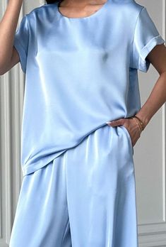 Light blue 2 piece satin loose fit set stylish and elegant!  The suit consists of a crew neck top with short sleeves and palazzo trousers with convenient pockets.  The suit will be an excellent choice for various occasions for an elegant casual look for every day, walks, as well as for special occasions for wedding guests, parties, family celebrations, receptions and more.    DETAILS - light blue  - satin  - loose fit - crew neck - short sleeve - wide leg   SIZES   This suit is available in 4 sizes S, M,  L and XL  T-shirt back length 24"/ 61 cm Shoulder 4.7"/ 12 cm  Pants inseam 29"/ 74 cm Outseam 41.33"/ 105 cm    S BUST 34 inches / 88 cm WAIST 26 inches /67 cm HIPS 37 inches / 96 cm M  BUST 36 inches / 92 cm WAIST 28 inches / 71 cm HIPS 39 inches / 100 cm L BUST 37.8"/ 96 cm WAIST 29.5" Summer Silk Sets With Short Sleeves, Elegant Silk Short Sleeve Sets, Blue Satin Sets For Summer, Elegant Short Sleeve Satin Set, Elegant Solid Color Short Sleeve Sets, Elegant Short Sleeve Sets, Pantsuit Wedding Guest, Satin Pantsuit, Wedding Guest Suit