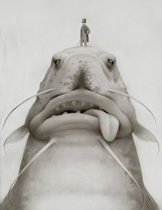 a man standing on top of a giant fish with its mouth open and tongue out