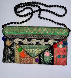 This is a New Handmade Purse/clutch in Vintage Style. It is made by vintage fabrics. It is multi-color purse. It is Beautifully decorated with vintage fabric, Sequins, Mirror and thread embroidery work along with nice print. It is containing a magnetic button enclosure and a tread chain string for easy carrying. It is contained two zipper pockets inside the bag. You can use this purse for marriage, Parties and Gifting purpose. The image may show slight differences to the actual bag in color, shape and texture. Bag Sizing (in Inches) approx. Length: "30approx. Width:   17"approx. The color may slightly differ due to different computer color setting. Shipping Policy: - We ship worldwide from India.  We ship parcels through Standard Shipping Service of India Post which provides proper trackin Festive Multicolor Embroidered Shoulder Bag, Festive Multicolor Embroidery Shoulder Bag, Festive Multicolor Shoulder Bag With Zari Work, Multicolor Shoulder Bag With Zari Work For Festive, Festive Multicolor Zari Work Shoulder Bag, Multicolor Zari Work Shoulder Bag For Festivals, Party Rectangular Shoulder Bag With Multicolor Embroidery, Party Multicolor Embroidered Rectangular Shoulder Bag, Vintage Handwork Clutch For Party