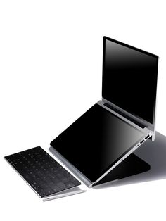 an open laptop computer sitting on top of a keyboard