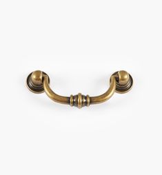 an antique brass door handle on a white background