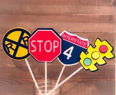 a group of street signs sitting on top of a wooden table