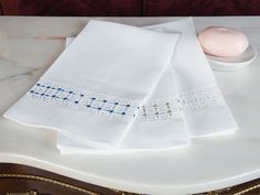 three white napkins on top of a table