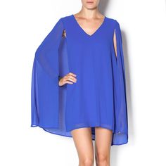 Blue Cape Dress. Color Is Most Accurate In First Picture. Purchased From A Boutique. Only Worn Once For A Wedding. In Great Condition. Lined Inside. Blue Flowy Cocktail Dress, Blue Flowy Elegant Mini Dress, Elegant Blue Flowy Mini Dress, Blue Cape, Dresses Blue, Cape Dress, One Pic, A Wedding, Blue Dresses