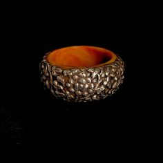 "Engraved  sterling silver Tibetan floral motif on resin statement bangle bracelet  Diameter  2.95\"   Height 1.65\"" Traditional Amber Jewelry With Carved Details, Handmade Bakelite Bracelets As Gift, Handmade Round Bakelite Jewelry, Carved Brown Bangle Jewelry, Brown Carved Bangle Jewelry, Brown Carved Bracelet Jewelry, Traditional Carved Bracelets For Formal Occasions, Brown Bakelite Jewelry As A Gift, Brown Bakelite Jewelry Gift