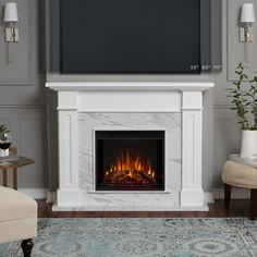 a living room with a white fireplace and blue rug on the floor next to it